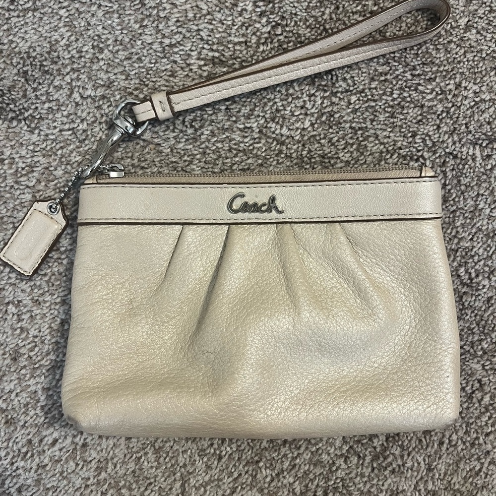 Small champagne Coach wristlet, leather with light purple interior